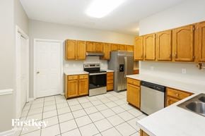 Charlotte house for rent - a kitchen with wooden cabinets and stainless steel appliances