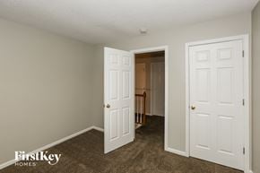 Charlotte house for rent - a bedroom with two closets and a door to a hallway
