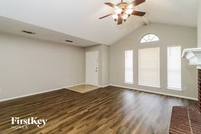 Fort Worth house for rent - the living room with hardwood floors and a ceiling fan