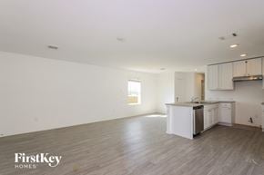 San Antonio house for rent - an empty kitchen and living room with white walls and wood floors