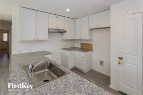San Antonio house for rent - an empty kitchen with white cabinets and a sink