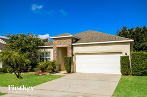 Haines City house for rent - a house with a white garage door and a lawn