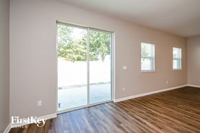Haines City house for rent - a living room with wood floors and a sliding glass door