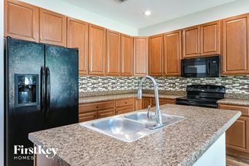 Haines City house for rent - a kitchen with a sink and a refrigerator