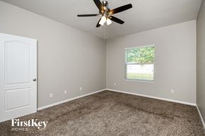 Haines City house for rent - a bedroom with carpet and a ceiling fan