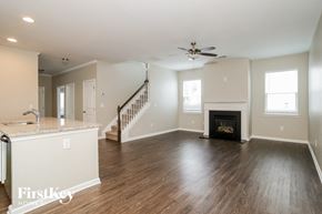 Canton house for rent - A spacious living room with a fireplace and a staircase.