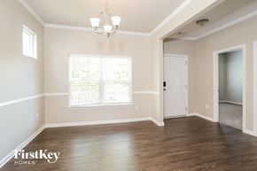 Canton house for rent - A room with wooden floors and a chandelier.