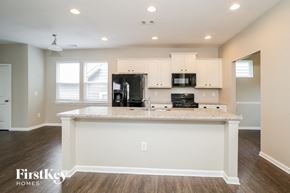 Canton house for rent - A kitchen with a white island and wooden floors.