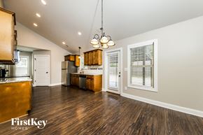 Kernersville house for rent - A well-lit kitchen with wooden floors and a FirstKey Homes logo.