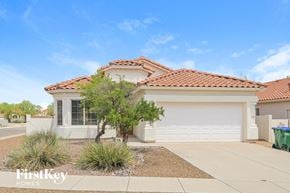Oro Valley house for rent - a home with a white garage door and a driveway