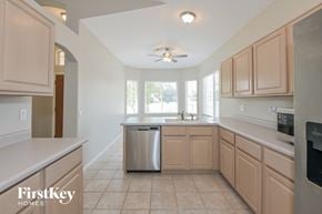 Oro Valley house for rent - a kitchen with wooden cabinets and a stainless steel dishwasher