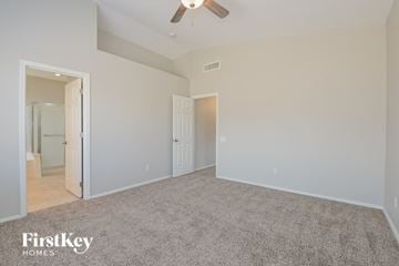 Oro Valley house for rent - a spacious living room with carpet and a ceiling fan