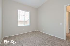 Oro Valley house for rent - a bedroom with a carpeted floor and a window