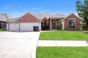 Edmond house for rent - a brick house with a garage and a lawn