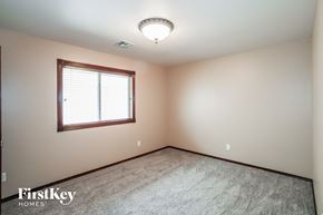 Edmond house for rent - a bedroom with a window and a carpeted floor