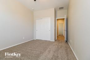 Surprise house for rent - a bedroom with a white door and a carpeted floor