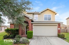 Cypress house for rent - the front exterior of a house with a garage door