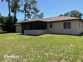 Fort Myers house for rent - a small white house in a grassy yard