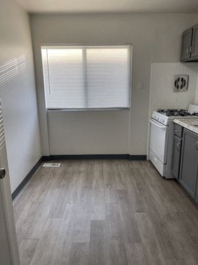 Jennings apartment for rent - an empty kitchen with a stove and a window