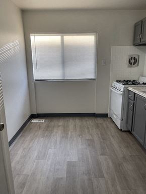 Jennings apartment for rent - an empty kitchen with a stove and a window