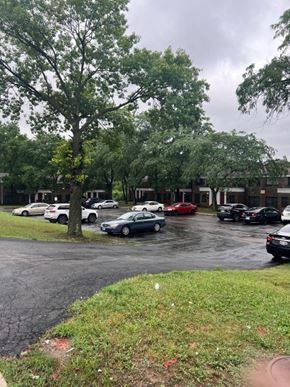 Jennings apartment for rent - a parking lot filled with cars in front of a building