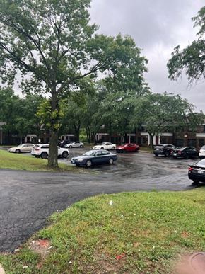 Jennings apartment for rent - a parking lot filled with cars in front of a building