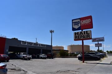 El Paso apartment for rent - A top shop body and paint garage with a hail repair sign in front.