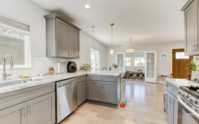 San Diego apartment for rent - A kitchen with a white counter top and grey cabinets.