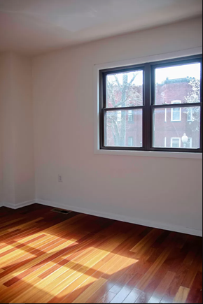 Washington apartment for rent - an empty room with a window and wooden floors