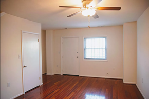 Washington apartment for rent - the living room of an empty house with a ceiling fan