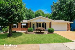 St Louis house for rent - a white and brick house with a lawn and trees