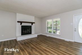 St Louis house for rent - a living room with a fireplace and wooden floors