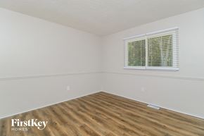 St Louis house for rent - a bedroom with a wood floor and a window