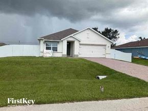 Cape Coral house for rent - a white house with a lawn in front of it