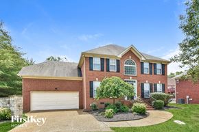 Hermitage house for rent - a brick house with a white garage door