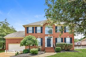Hermitage house for rent - a brick house with a white fence and a tree