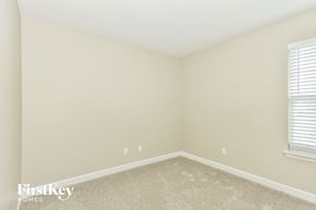 Hermitage house for rent - a bedroom with a carpeted floor and two windows
