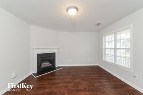 Winston Salem house for rent - the living room with wood flooring and a fireplace