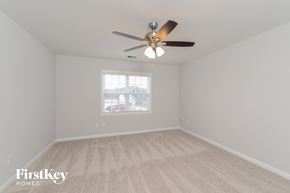 Winston Salem house for rent - a bedroom with a ceiling fan and a window