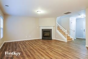 Raleigh house for rent - the living room with wood flooring and a fireplace