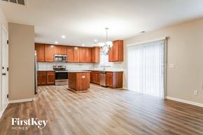 Raleigh house for rent - a kitchen and living room with wood flooring and wooden cabinets