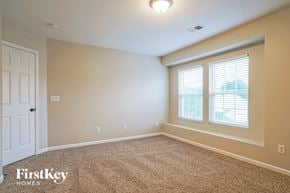 Raleigh house for rent - a bedroom with a large window and a white door