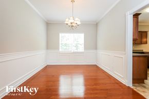 Moncks Corner house for rent - an empty dining room with white walls and wood floors