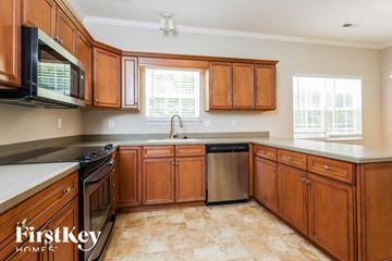 Moncks Corner house for rent - a kitchen with wooden cabinets and stainless steel appliances