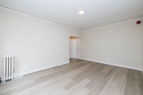 Oakland apartment for rent - A room with a white wall and a wooden floor.