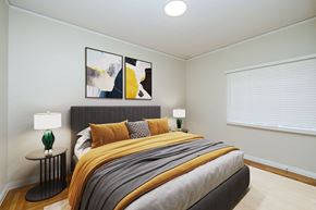 Oakland apartment for rent - A bedroom with a large bed and two lamps.