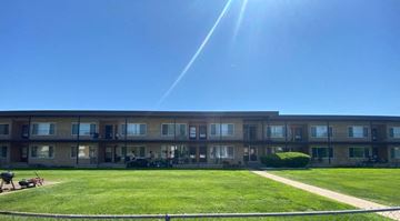 Westland apartment for rent - an apartment building with a green lawn and a blue sky