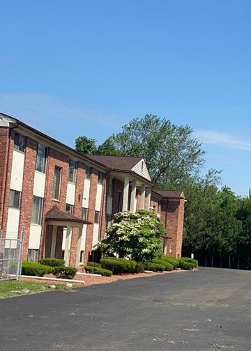 Westland apartment for rent - A large building with a white column in front.