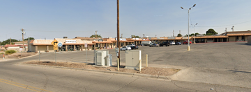 El Paso apartment for rent - A parking lot with a yellow sign and a pole with a box on top.