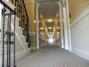 Los Angeles apartment for rent - A long hallway with a staircase on the left side.